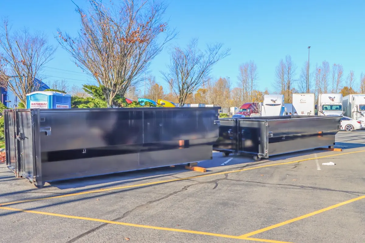 Professional dumpster rental service with roll-off container on residential driveway in Covedale